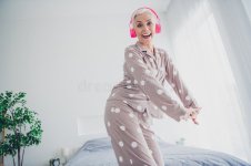 cheerful-senior-woman-polka-dot-pajamas-dancing-pink-headphones-bright-bedroom-filled-natural-...jpg